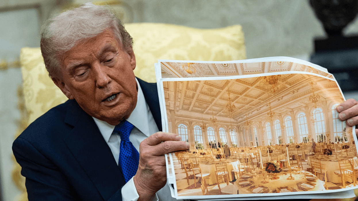 Donald Trump holding photos of White House ballroom