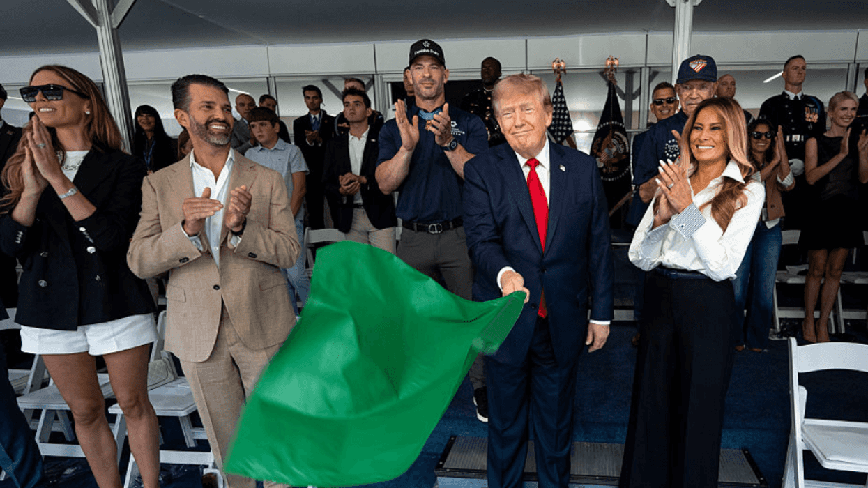Donald Trump waving green flag at IndyCar race