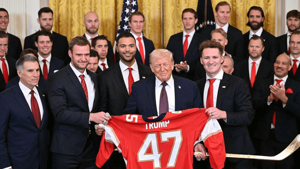 Donald Trump with shirt presented to him by U.S. men's hockey team players