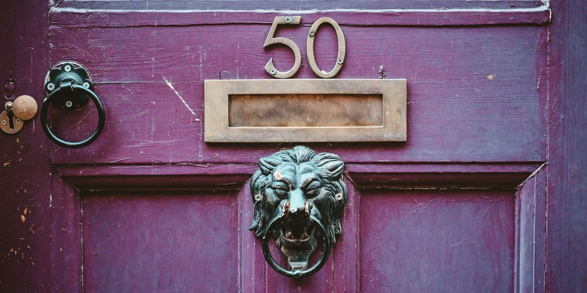 door with brass 50 and lion's head doorknocker