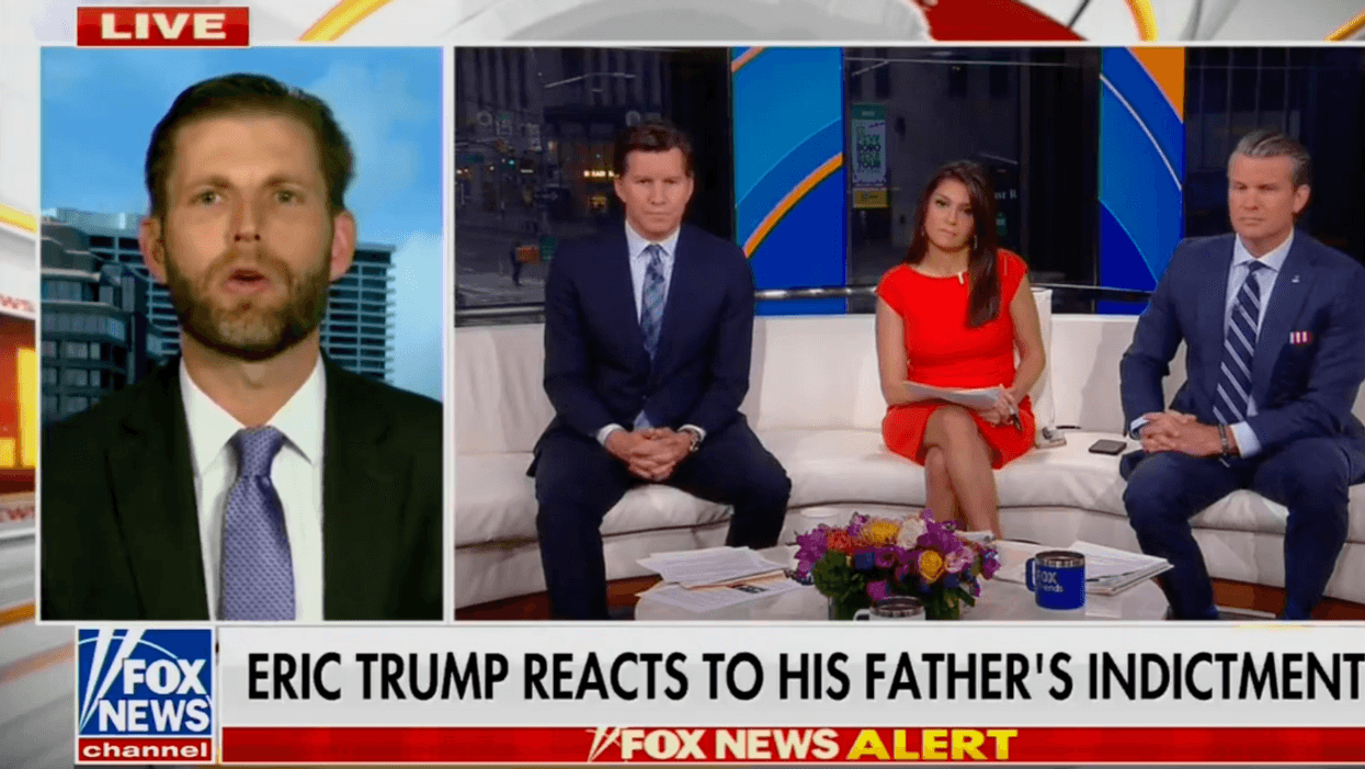 Eric Trump appears on a Fox News broadcast alongside 3 Fox News hosts. The lower third graphic reads "Eric Trump reacts to his father's indictment."