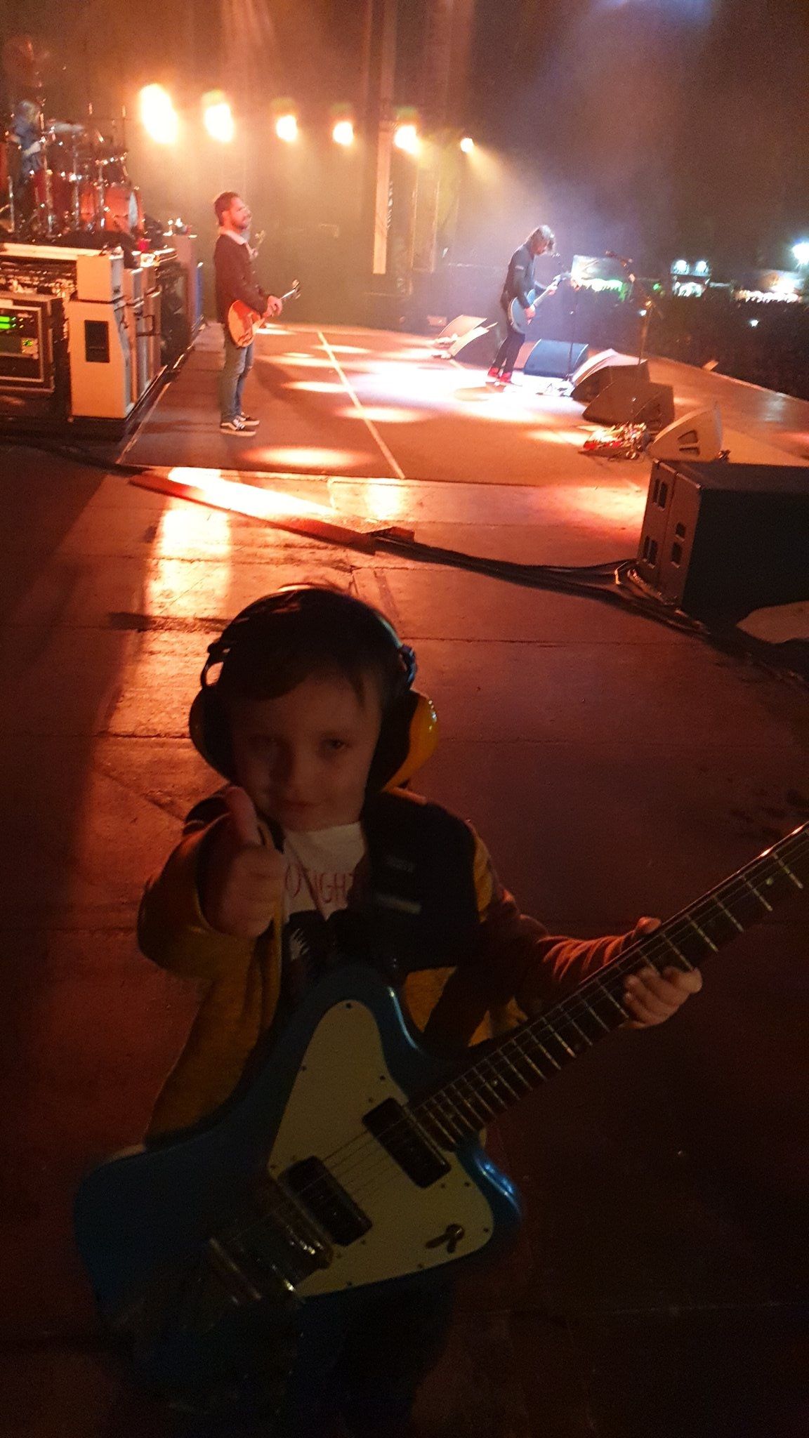 Taylor Blackburn on stage in Belfast with a guitar