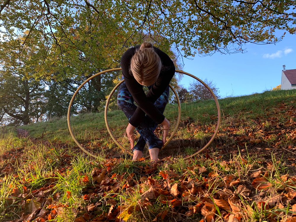 Woman in field with wooden hoops