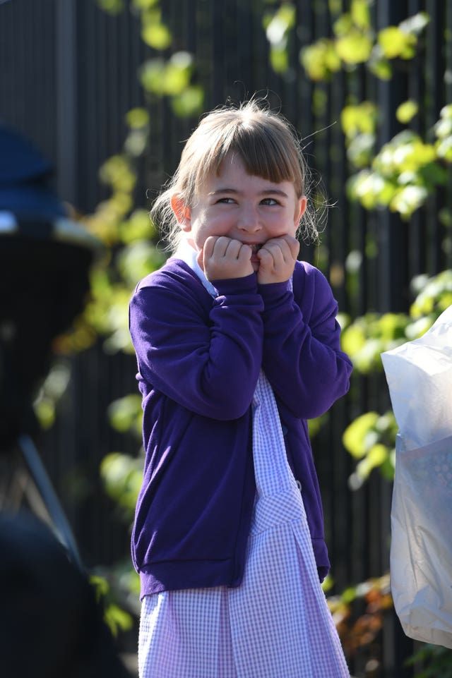 A pupil waits to head into school