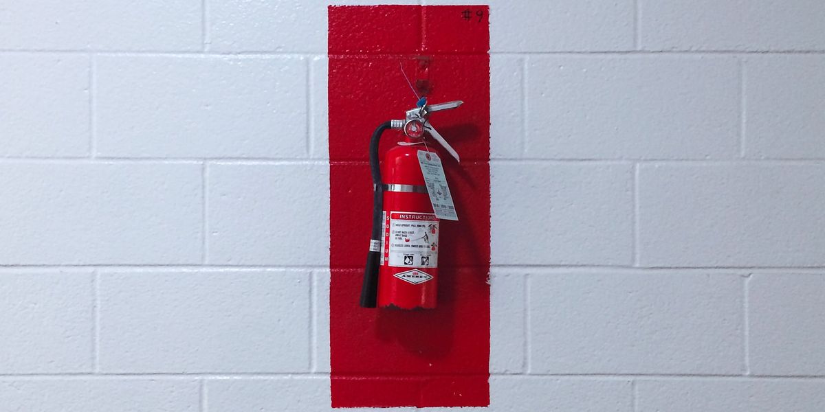 Fire extinguisher hung on wall
