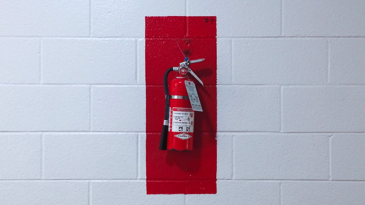 Fire extinguisher hung on wall