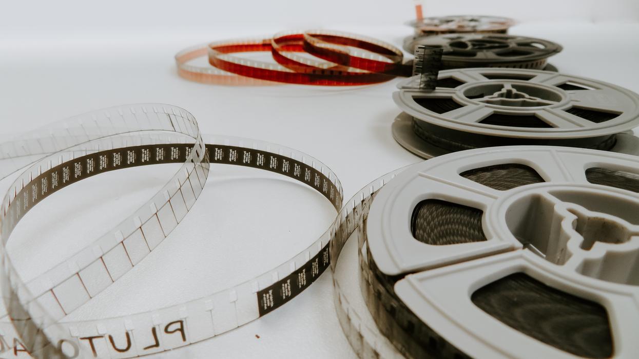 four reel films lying on white table