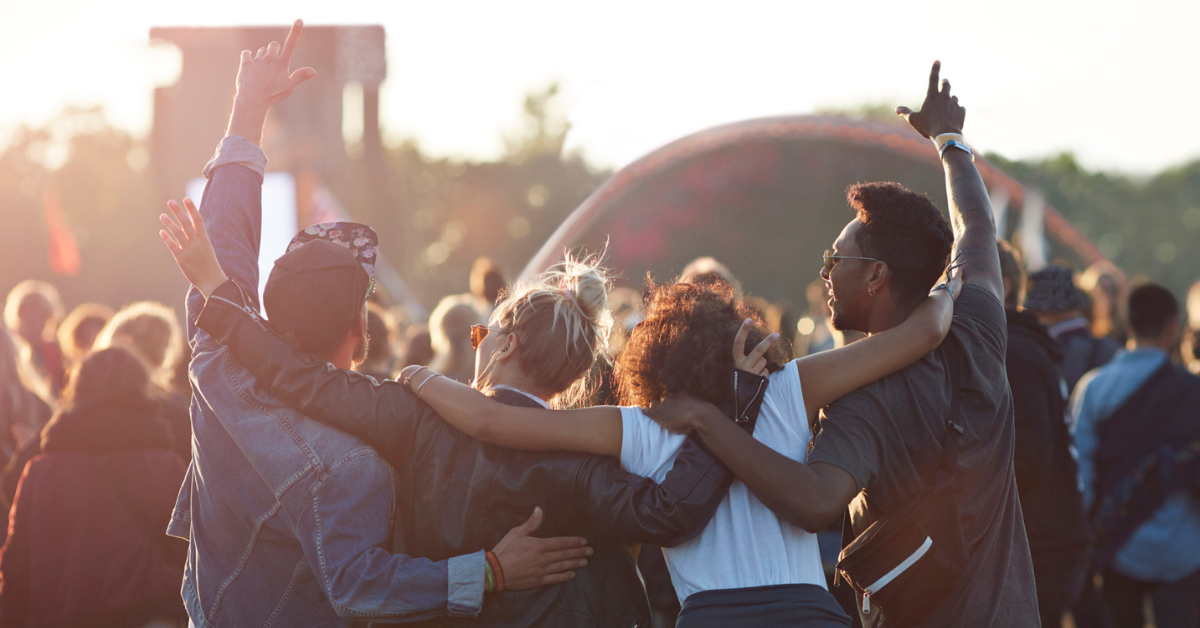 four young people at an outdoor concert