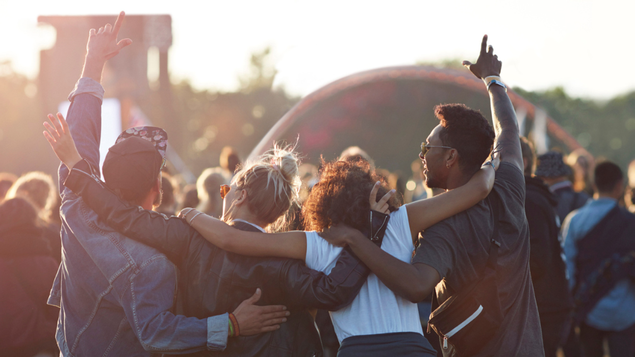 four young people at an outdoor concert