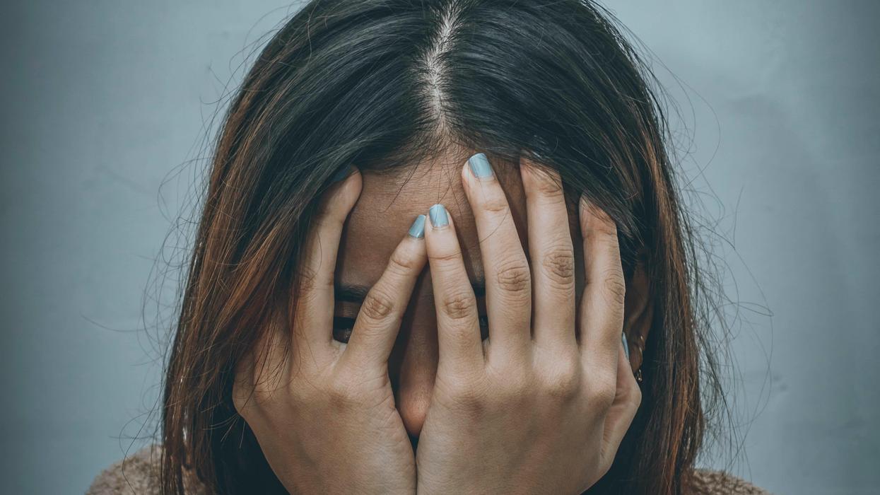 Frustrated woman covering her face