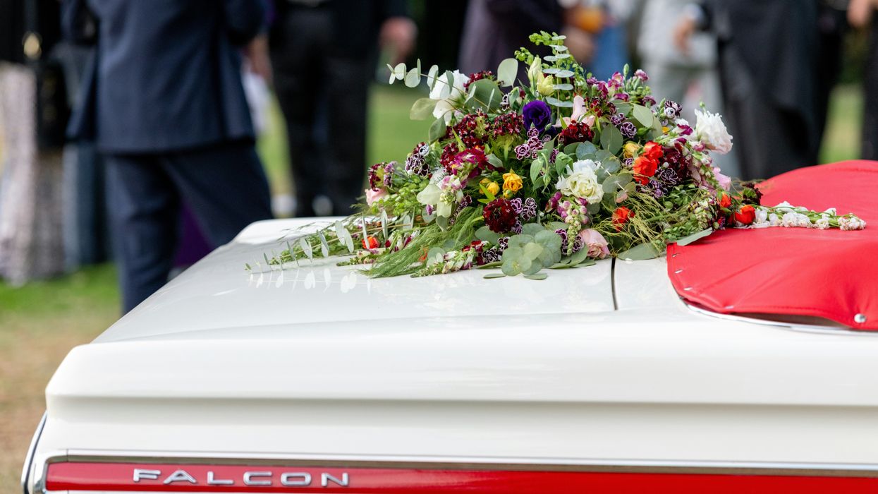 funeral flowers on trunk of car