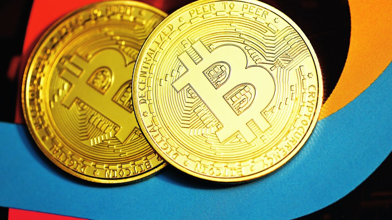 gold round coin on blue textile