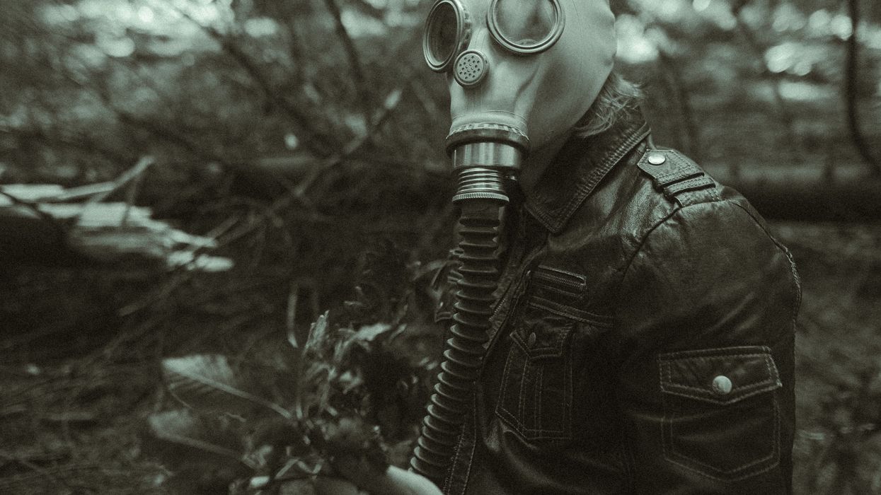 grayscale photo of person wearing gas mask and leather jacket