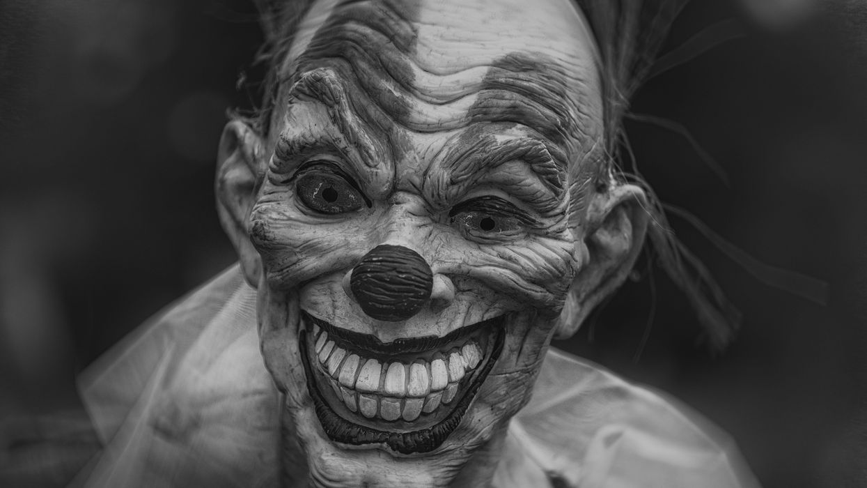 grayscale photography of person wearing clown mask