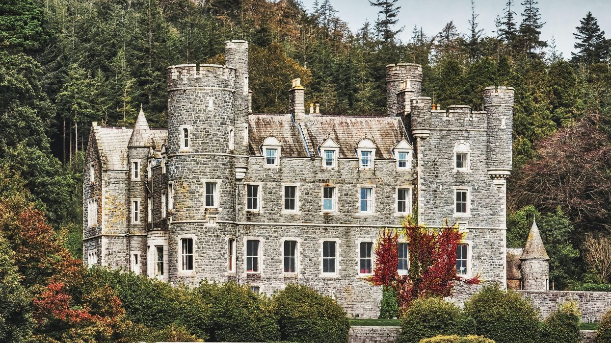 grey concrete building near trees during daytime