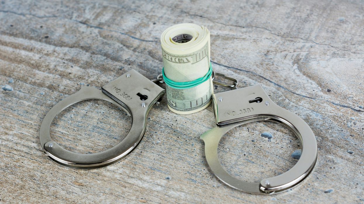 handcuffs and roll of American cash