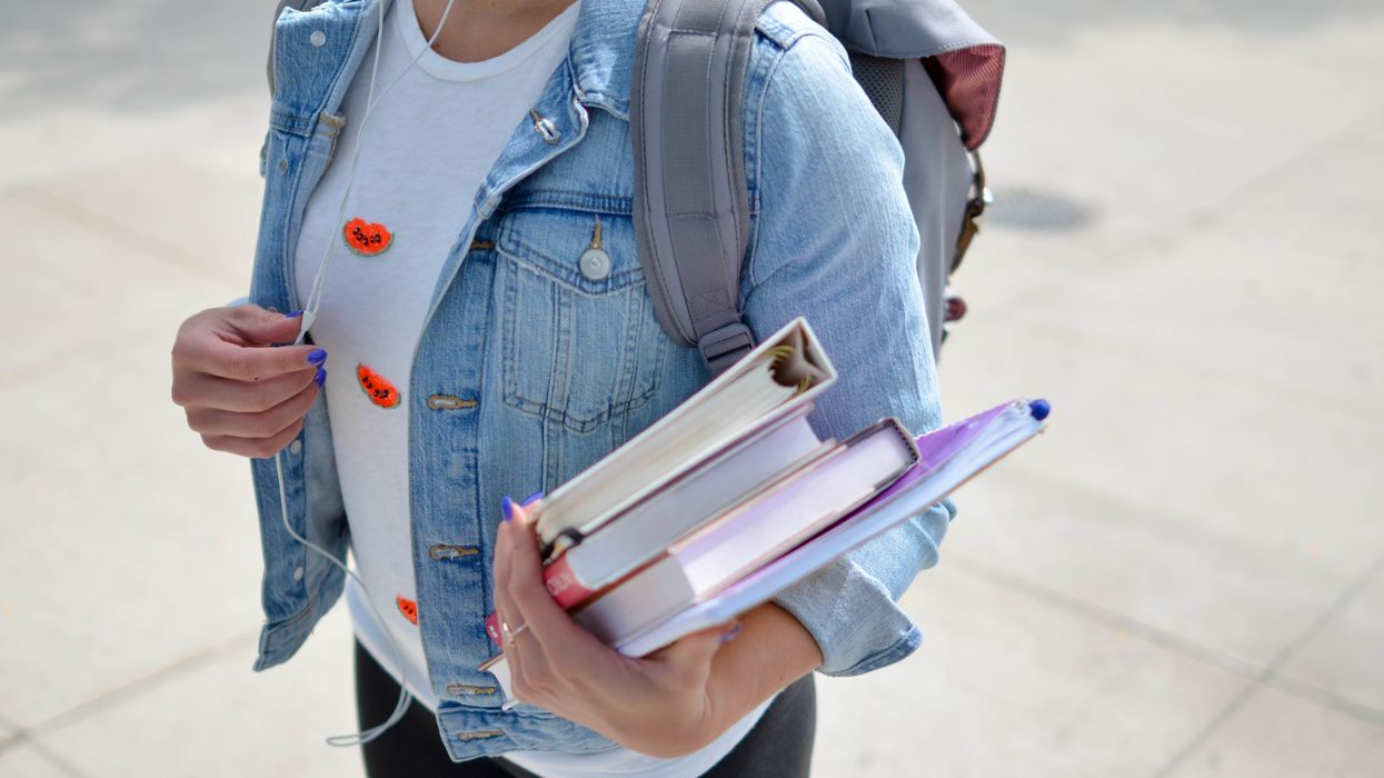 High school student carrying text books.