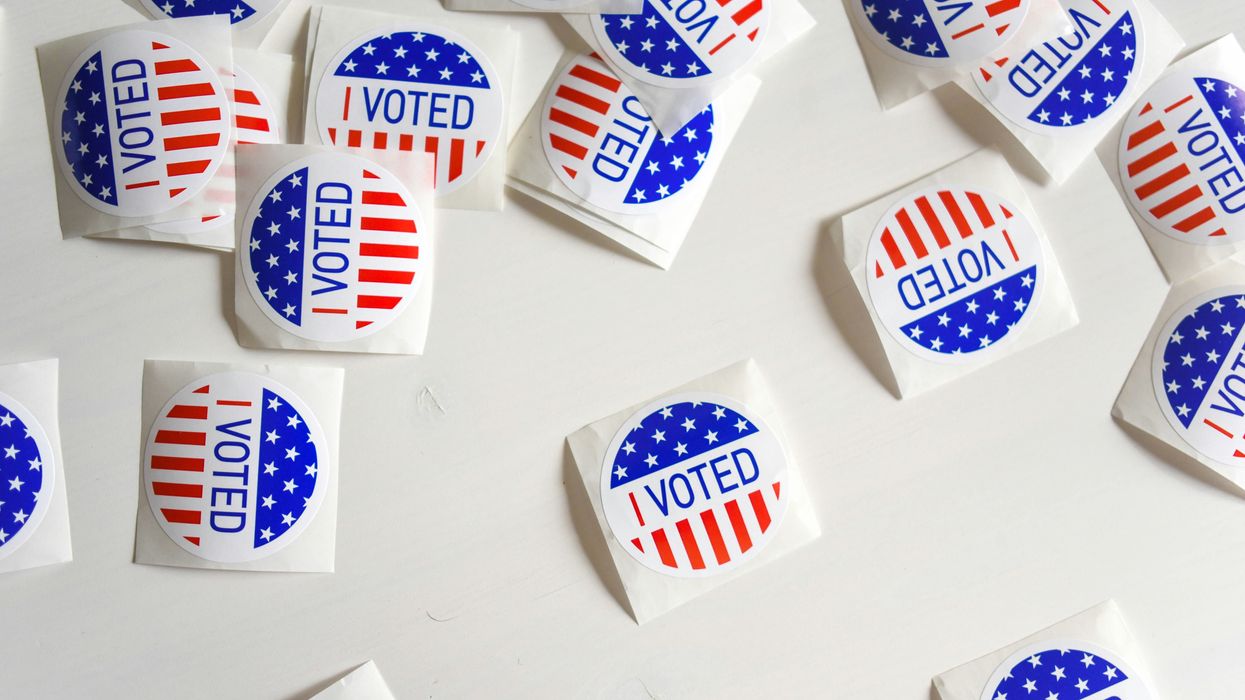 "I Voted" stickers laid out over a table.