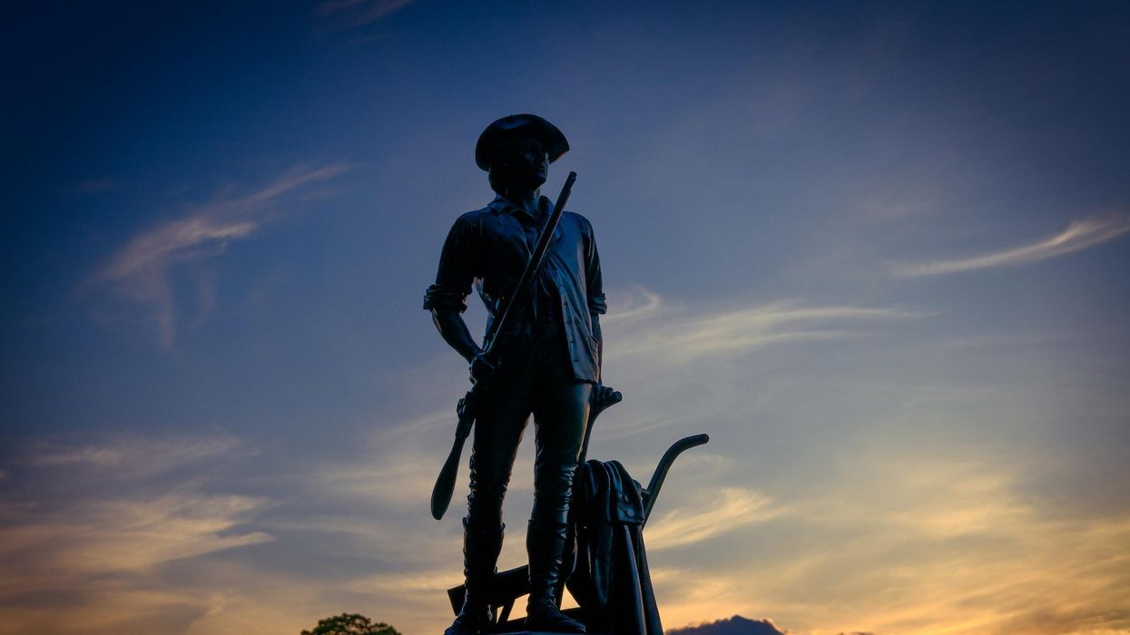 Image of a confederate statue against the background of the sunset