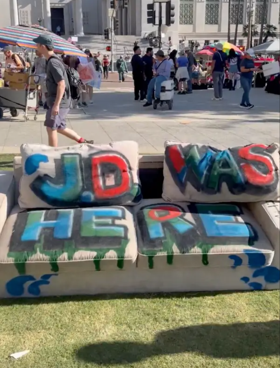Image of couch with "JD WAS HERE" message