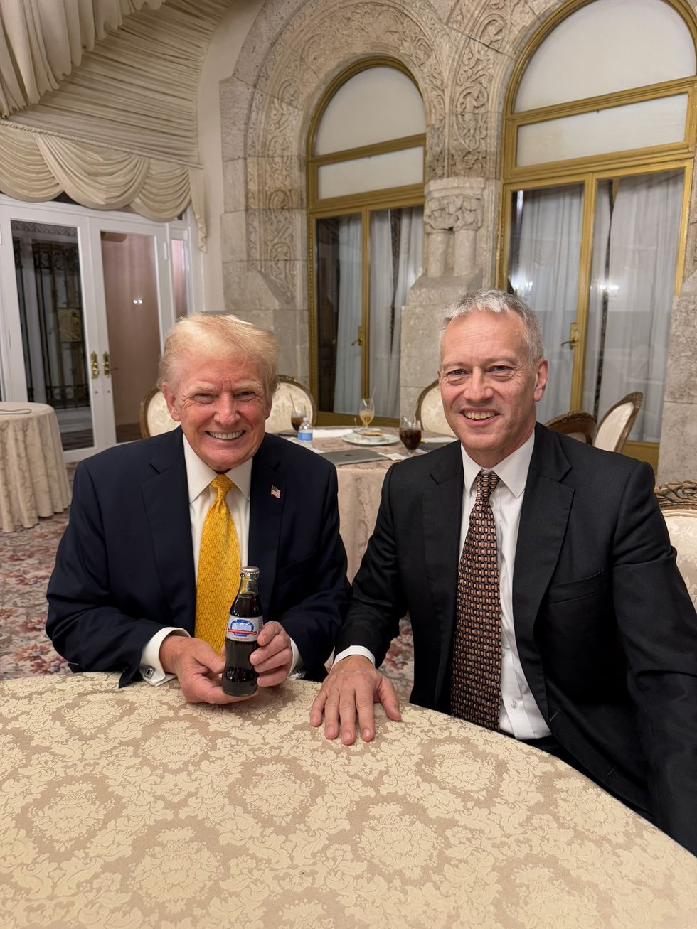 Image of Donald Trump and James Quincey with the Trump Diet Coke bottle