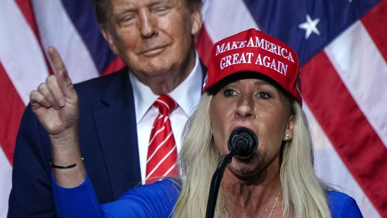 Image of Marjorie Taylor Greene in a 'Make America Great Again' hat with Donald Trump