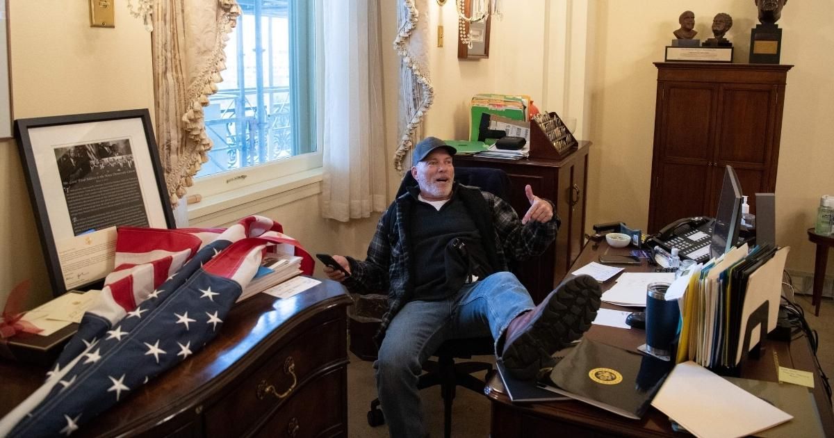 Capitol Rioter Pictured Lounging In Pelosi's Office Screams 'It's Not Fair' At Judge Over Pre-Trial Jailing