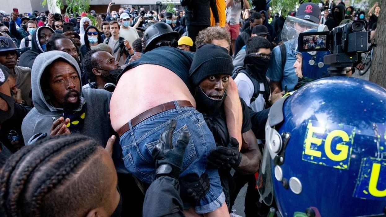 Black Lives Matter Supporter Who Was Photographed Carrying Injured Far Right Counter-Protester To Safety Speaks Out