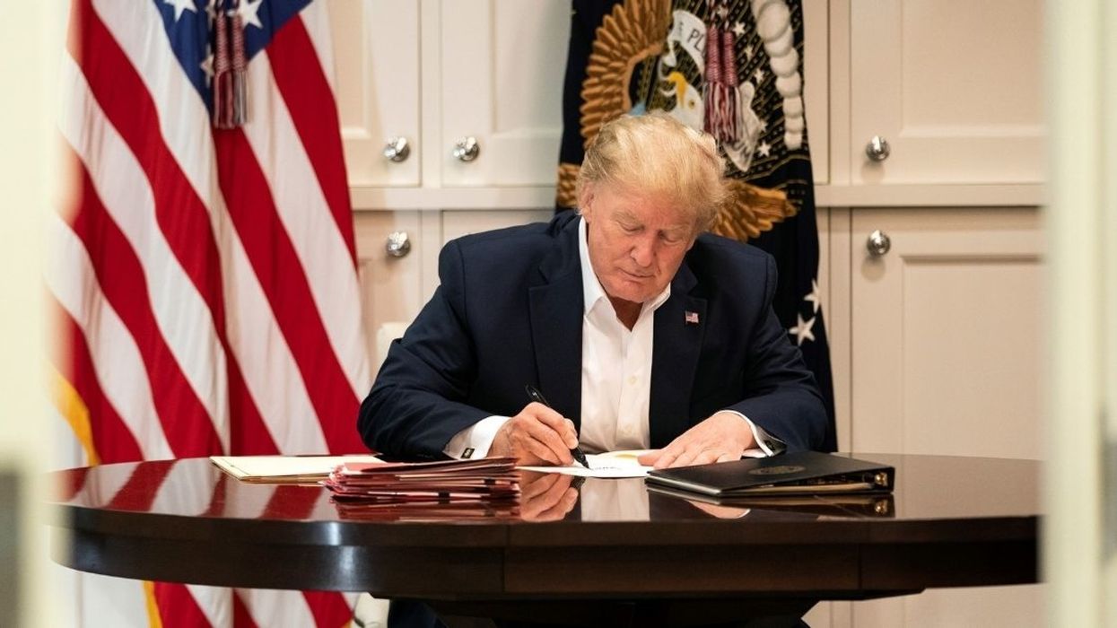 Trump Dragged After Photo Of Him 'Working' At Walter Reed Shows Him Signing A Blank Sheet Of Paper