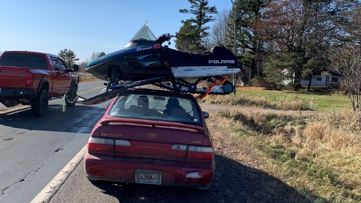 Driver Pulled Over For Having A Snowmobile Precariously Strapped To The Roof Of His Car