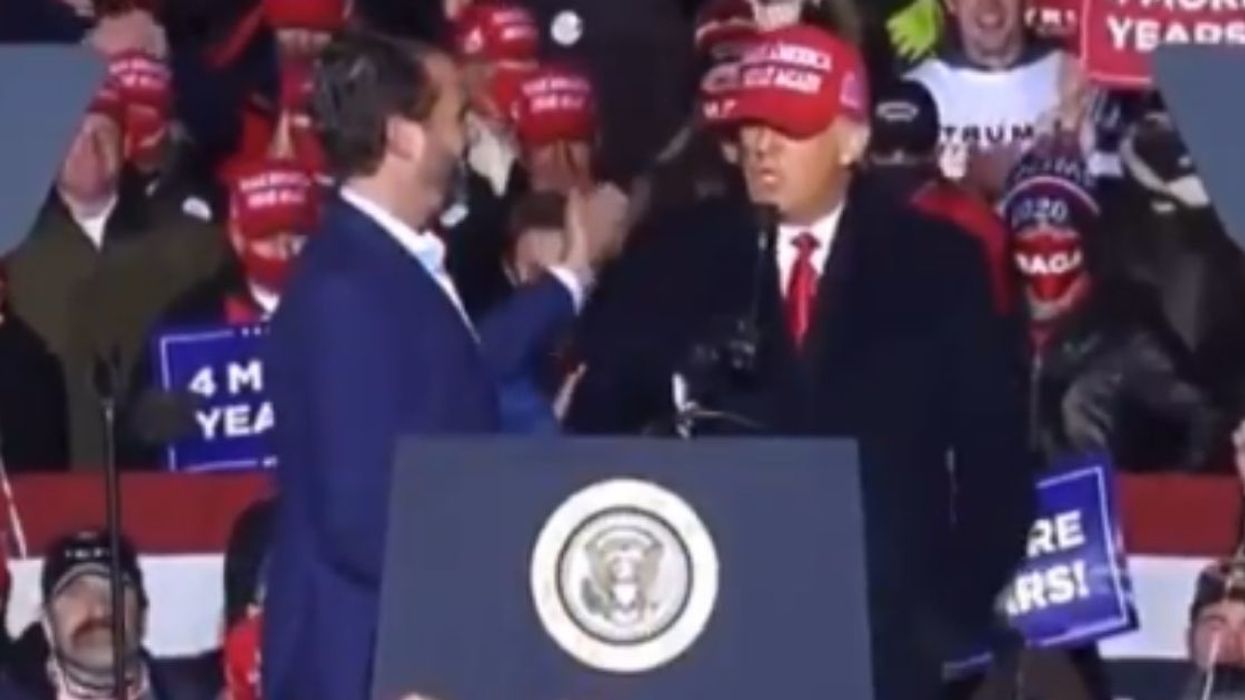 Twitter LOLs Over Awkward Video Of President Trump Appearing To Reject A Hug From Don Jr.
