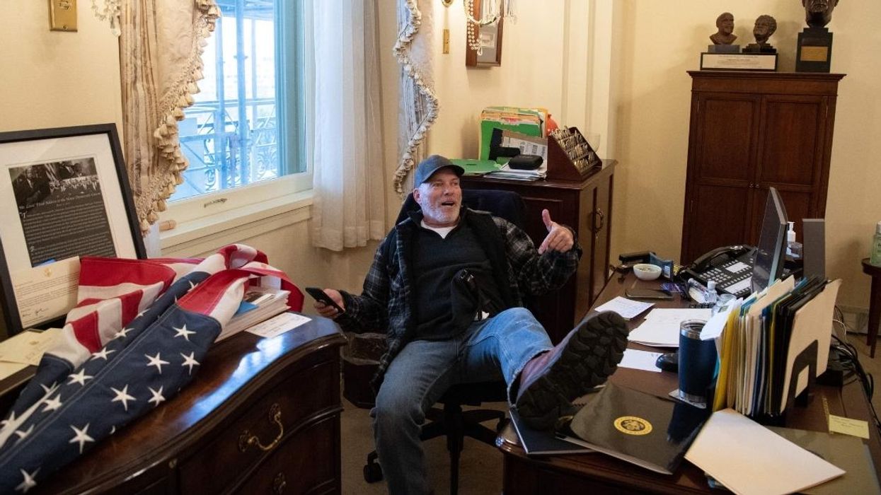 Capitol Rioter Pictured Lounging In Pelosi's Office Screams 'It's Not Fair' At Judge Over Pre-Trial Jailing