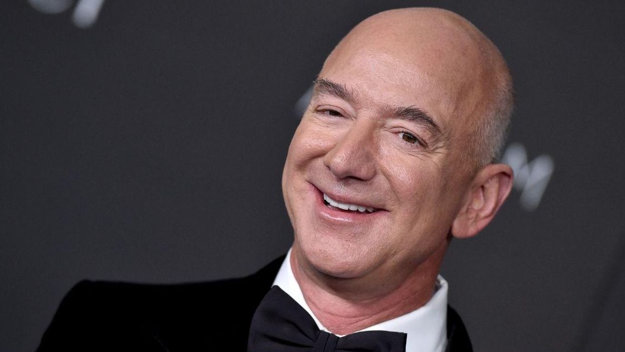 Jeff Bezos Roasted After Posing With A 'Lord Of The Rings' Sign To Promote New Amazon Series
