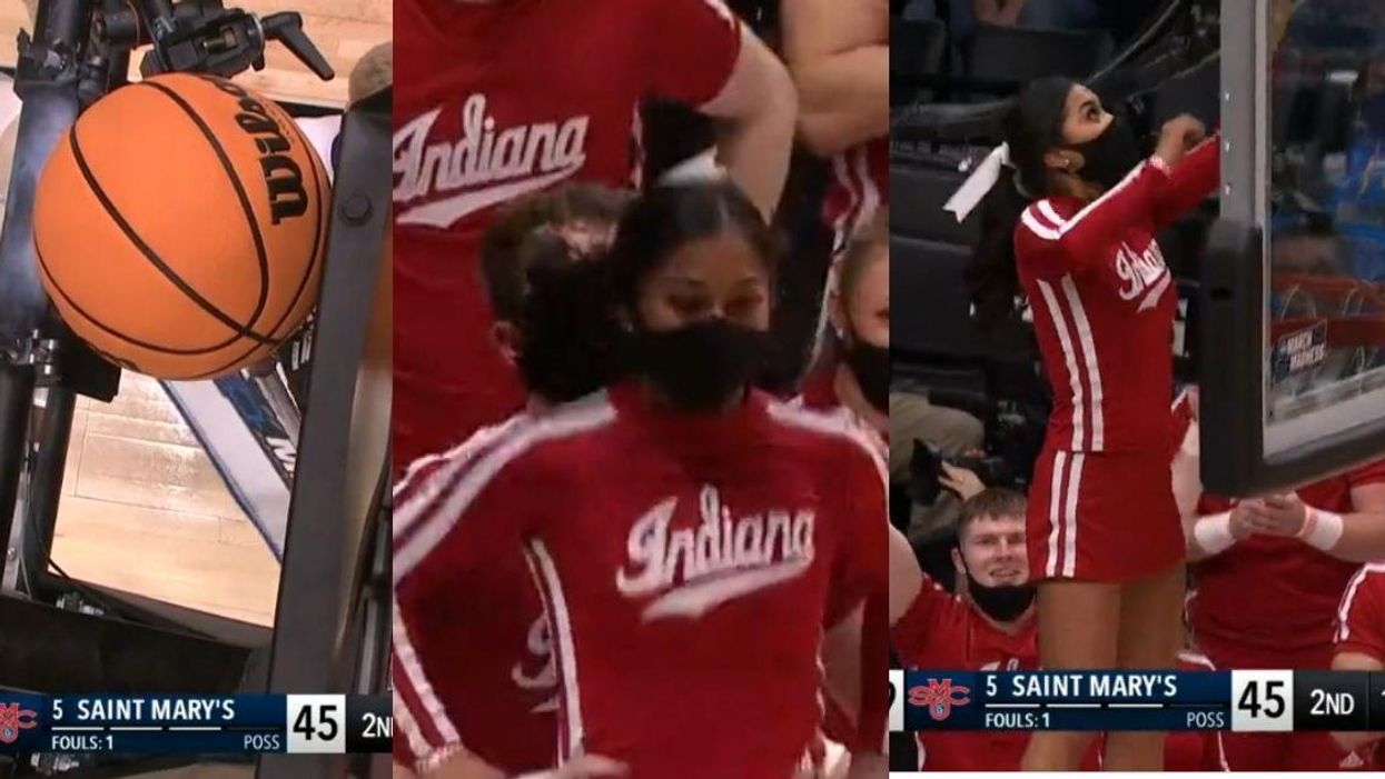 Indiana Cheerleader Saves The Day After Basketball Gets Stuck Behind Backboard During Game