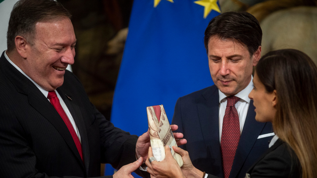 Italian Woman Gives Mike Pompeo Large Block Of Cheese To Protest Trump's Potential Cheese Tariffs