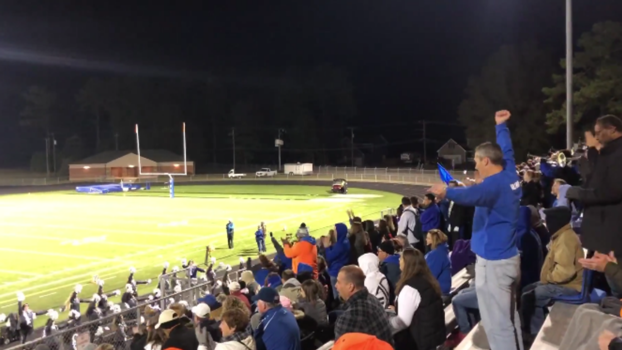 Enthusiastic 'Cheer Dad' Goes Viral For Doing Daughter's Cheerleader Moves In Stands As She Performs