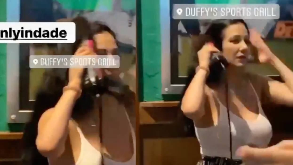 Woman Becomes Instant Icon After She's Filmed Styling Her Hair At A Crowded Sports Bar