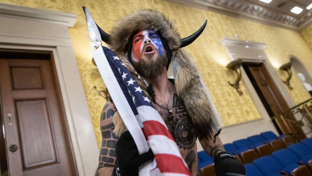 Infamous 'QAnon Shaman' Offers Bonkers New Claim For What He Was Really Doing On Jan. 6
