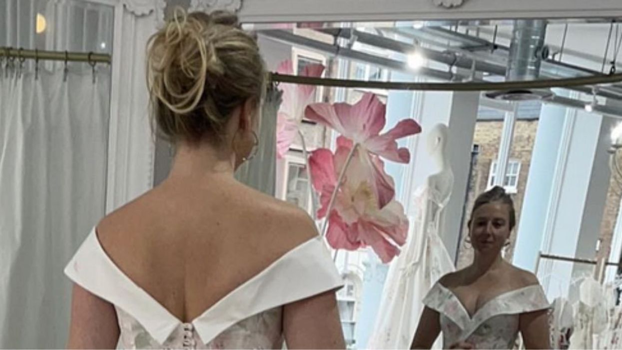 Instagrammer @wheatpraylove in a wedding gown looking in a mirror