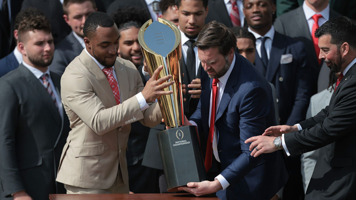 J.D. Vance with NCAA football trophy