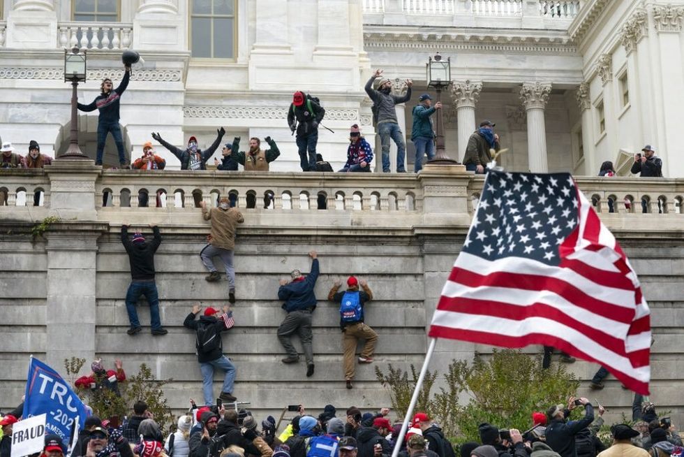 January 6 rioters waving different flags
