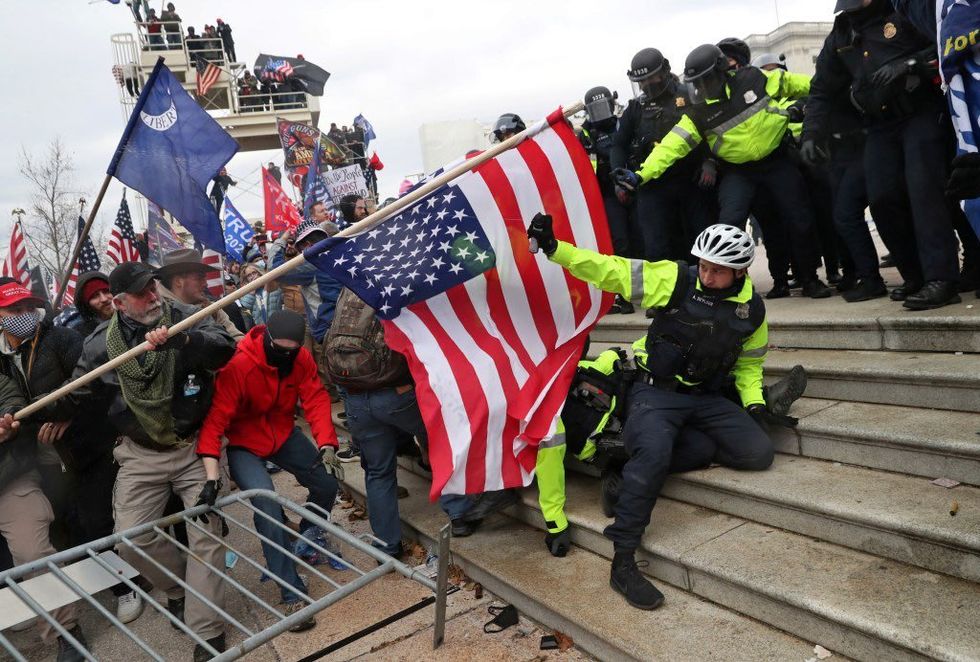 January 6 rioters waving different flags