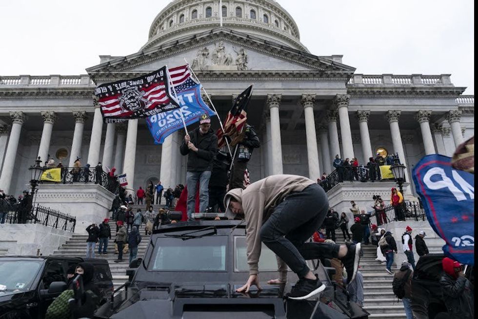 January 6 rioters waving different flags