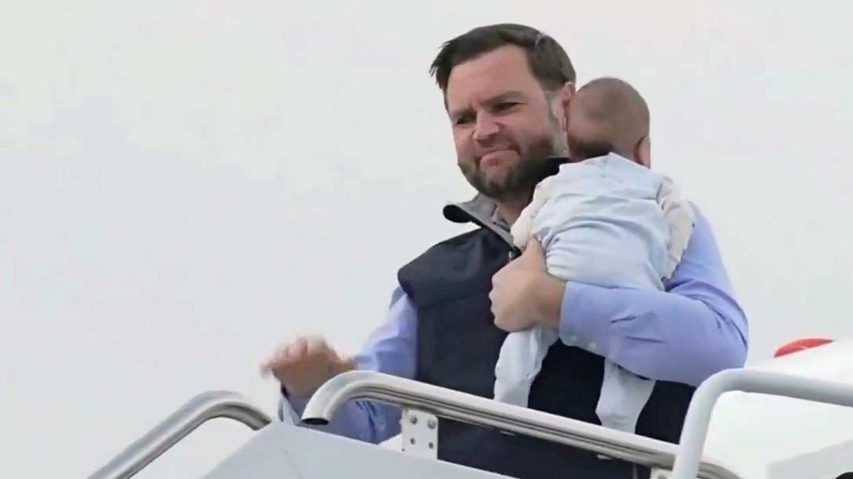 JD Vance carrying his child