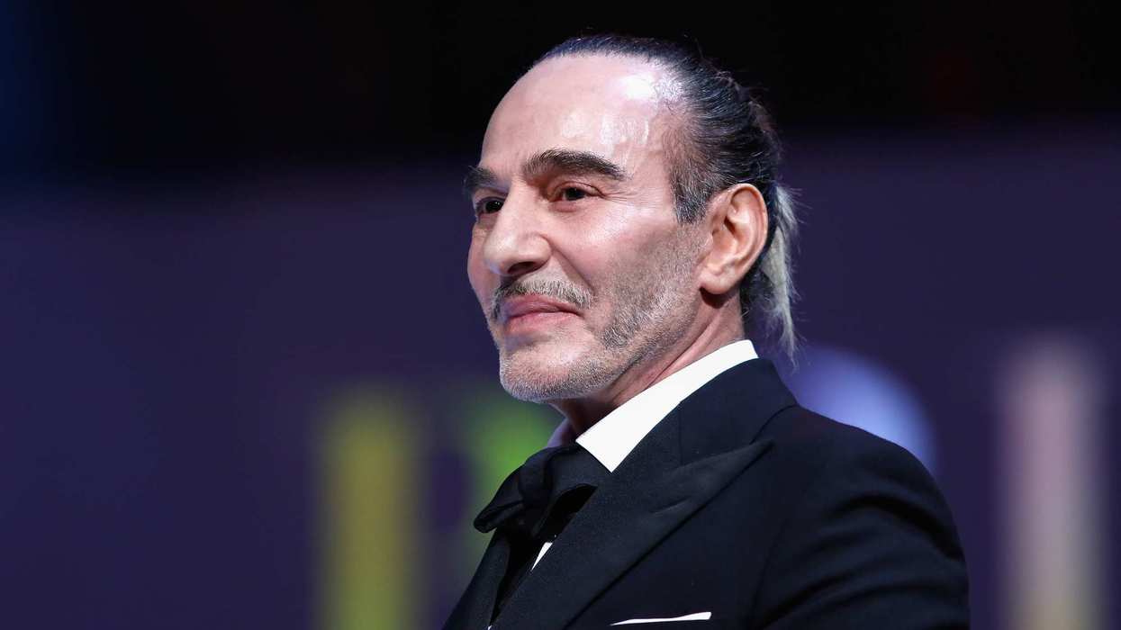 John Galliano presents the British Emerging Talent Menswear award on stage during The Fashion Awards.