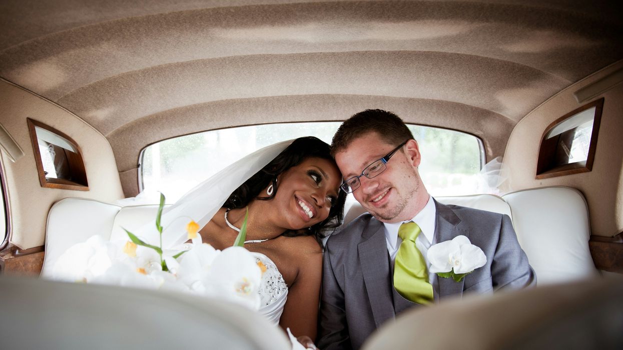 Just married white groom with Black bride