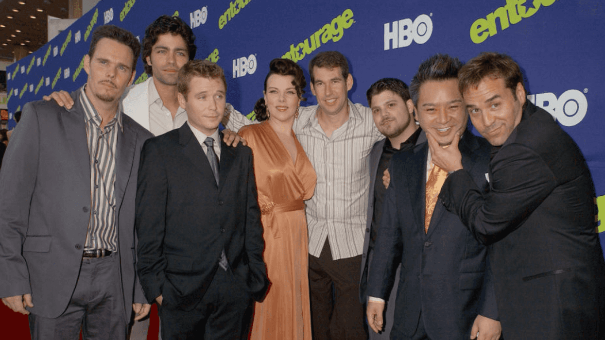 Kevin Dillon, Adrian Grenier, Kevin Connolly, Debi Mazar, Doug Ellin, Jerry Ferrara, Rex Lee and Jeremy Piven posing on a red carpet event in front of an "Entourage" step and repeat.
