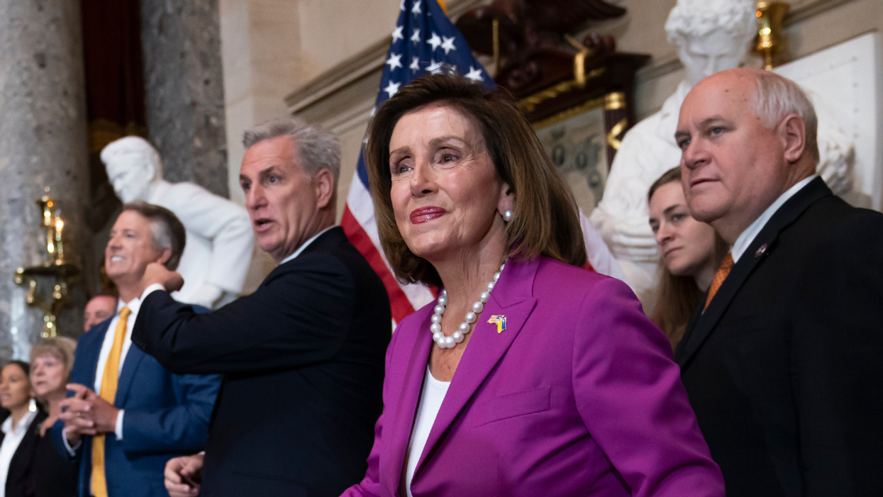 Kevin McCarthy and Nancy Pelosi flanked by other members of Congress