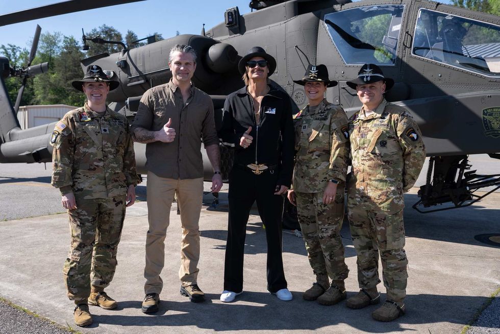 Kid Rock posing with Pete Hegseth and soldiers