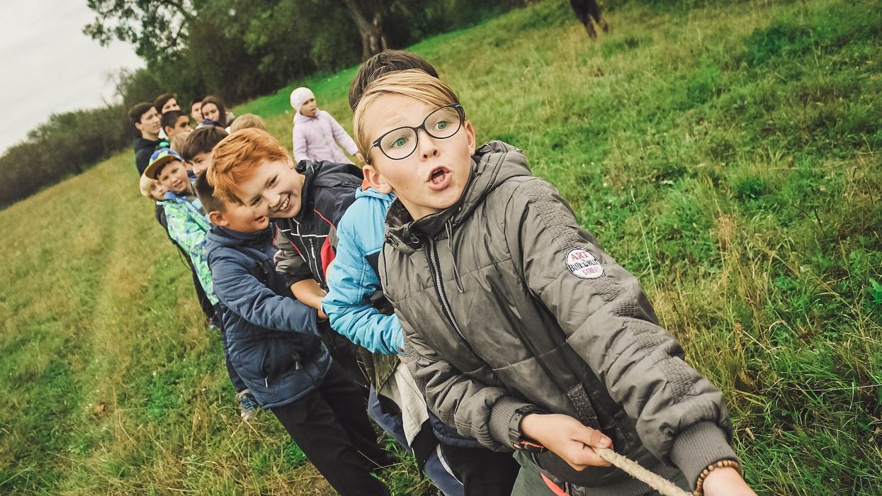Kids pull on a rope in a tug of war